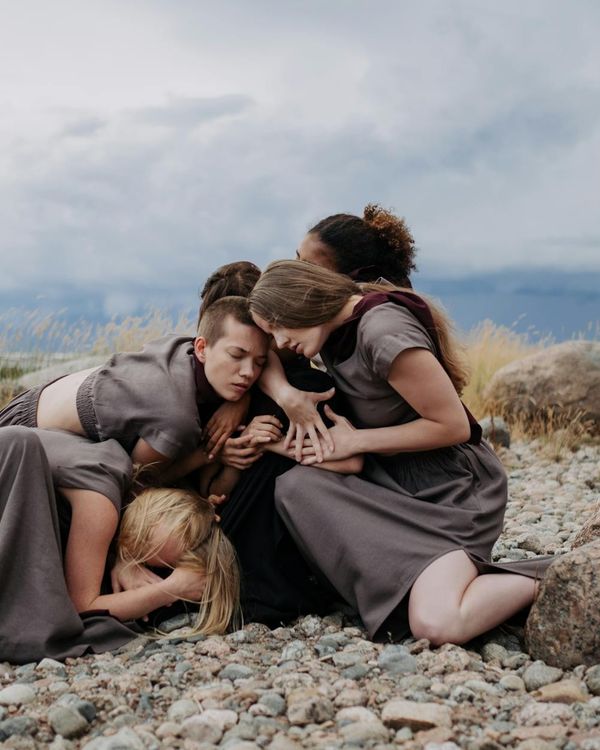 Woman in a dynamic and fluid movement pose in a calm setting.